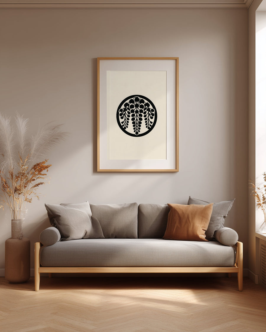Sagari-fuji wisteria kamon print in black on cream, framed above a grey sofa in a japandi living room