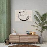 Maru sleeping cat print hung above a low wooden sideboard beside a potted palm, Yugen Print