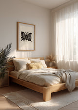 Agehachō butterfly kamon print in black on cream, framed above a light oak bed in a serene Scandinavian bedroom