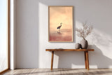 Crane at Dawn print in an oak frame above a narrow wood console in a bright entryway