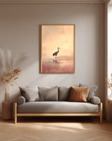 Crane at Dawn print in an oak frame above a grey linen sofa in a neutral living room
