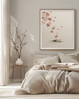 Falling Sakura cherry blossom print hanging above a linen-dressed bed with a ceramic vase and branches, soft morning light bedroom, Yugen Print