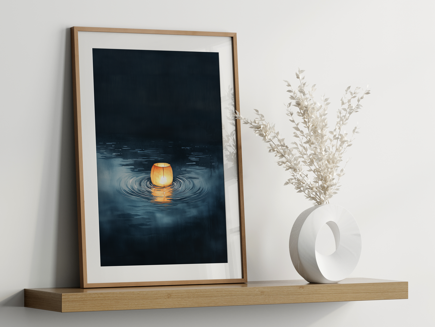 Sumi-e style indigo ink print of a single paper lantern glowing on still water, oak frame leaning on a floating wood shelf beside a white ceramic vase, Yugen Print