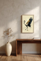 Golden Crane Rising print shown framed in a room above a console table, a red-crowned crane steps forward with wings spread, black feathers splashing ink and gold seams through its white wing