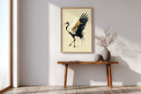 Golden Crane Rising print shown framed in an entryway, a red-crowned crane steps forward with wings spread, black feathers splashing ink and gold seams through its white wing