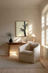 Golden Seam Bamboo print shown framed in a Scandi living room (4:5 version), a dark ink bamboo stalk with gold kintsugi seams along its joints on a parchment ground