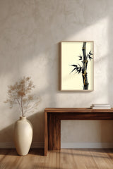 Golden Seam Bamboo print shown framed in a room above a console table, a dark ink bamboo stalk with gold kintsugi seams along its joints on a parchment ground
