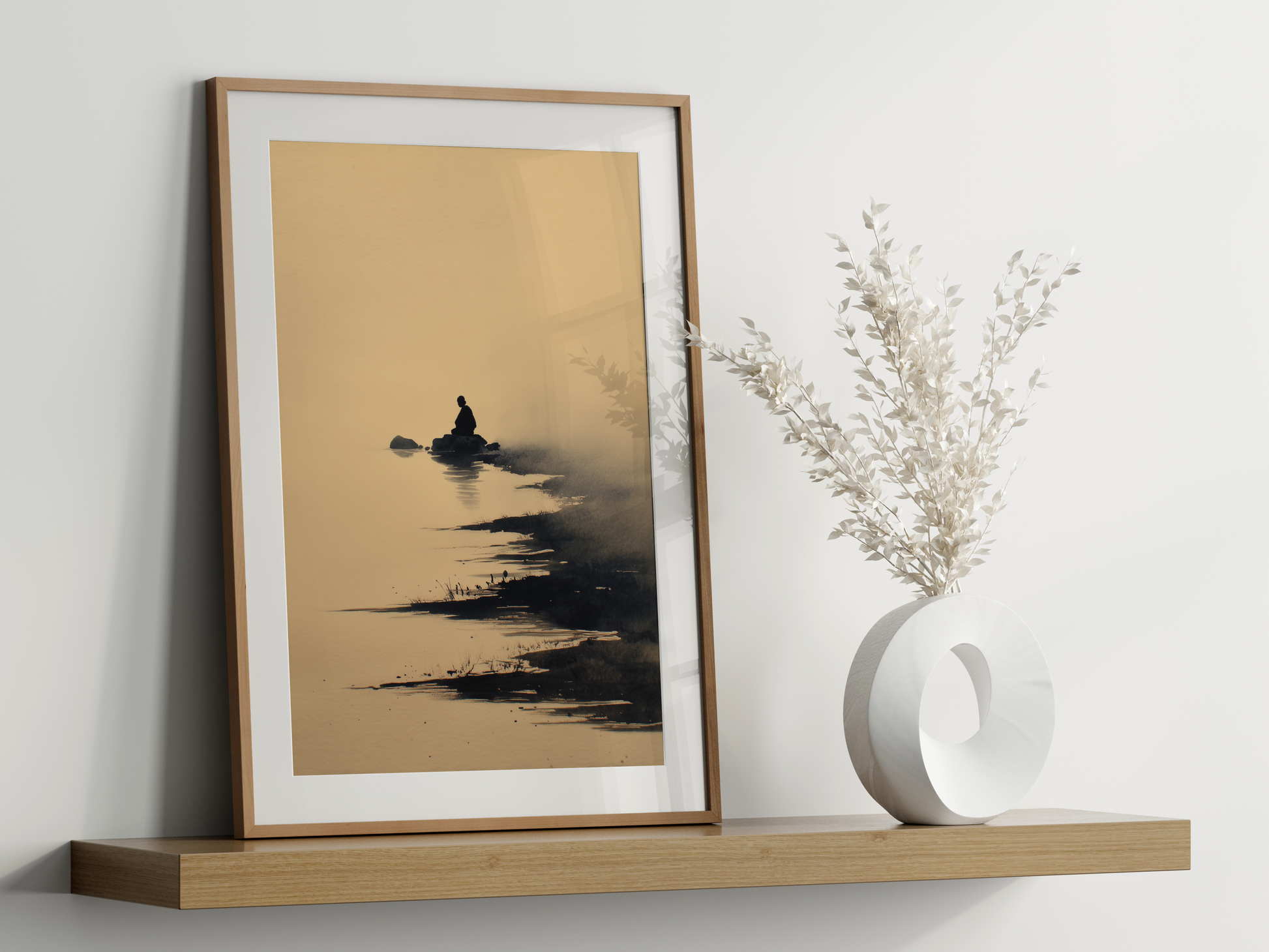Sumi-e style ink print of a lone figure on a rock in misty water, framed in oak on a floating shelf beside a white vase, Yugen Print