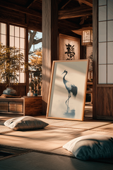 Japanese crane wall art in a wood frame leaning in a traditional tatami room with floor cushions, shoji screens, and warm afternoon light.