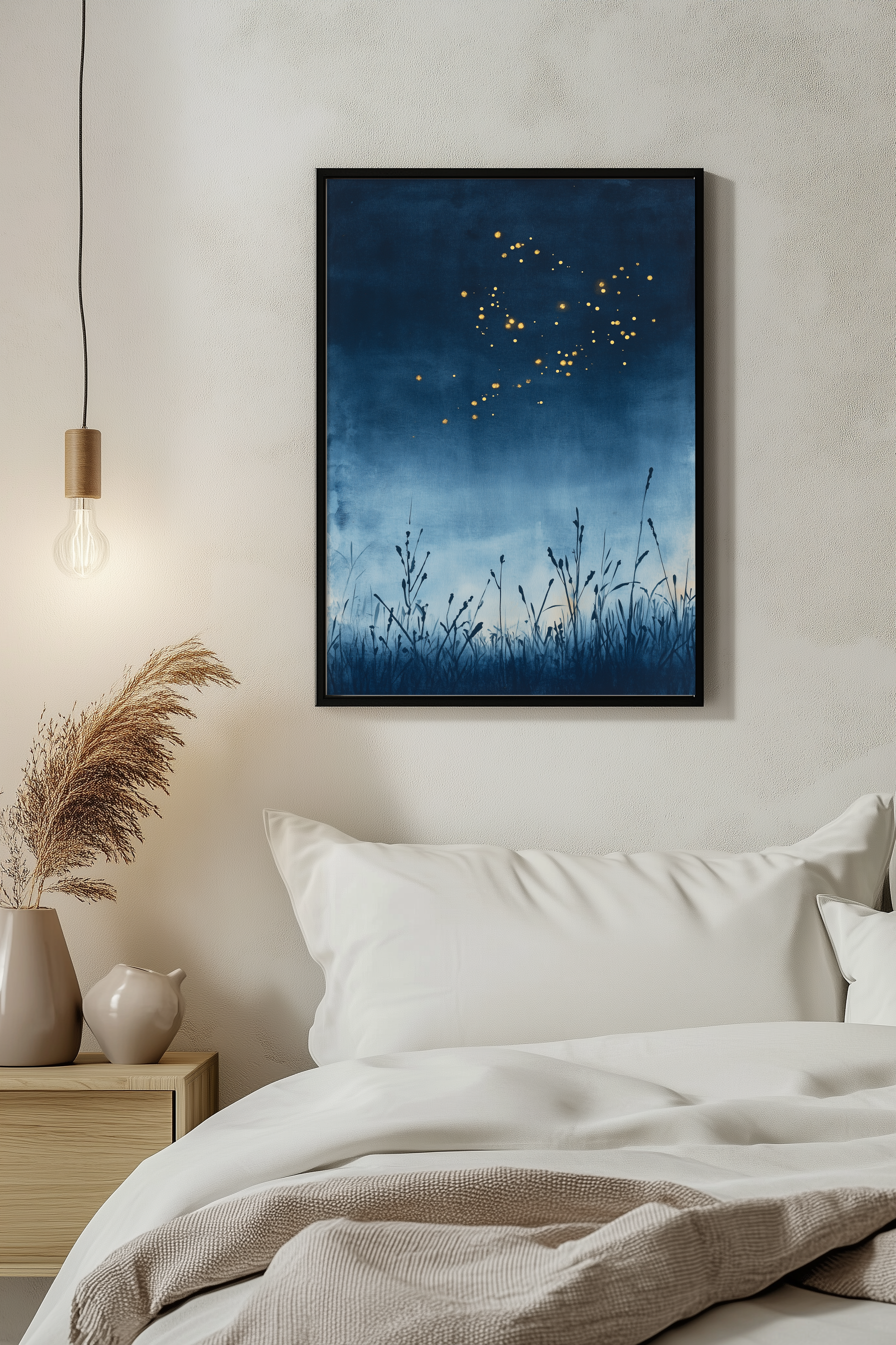 Sumi-e style indigo ink print of fireflies drifting over a summer night, black frame above white bedding beside a warm pendant light in a serene evening bedroom, Yugen Print