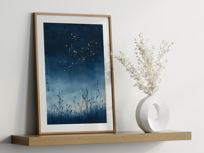 Sumi-e style indigo ink print of golden fireflies over night reeds, oak frame leaning on a floating wood shelf beside a white ceramic vase, Yugen Print
