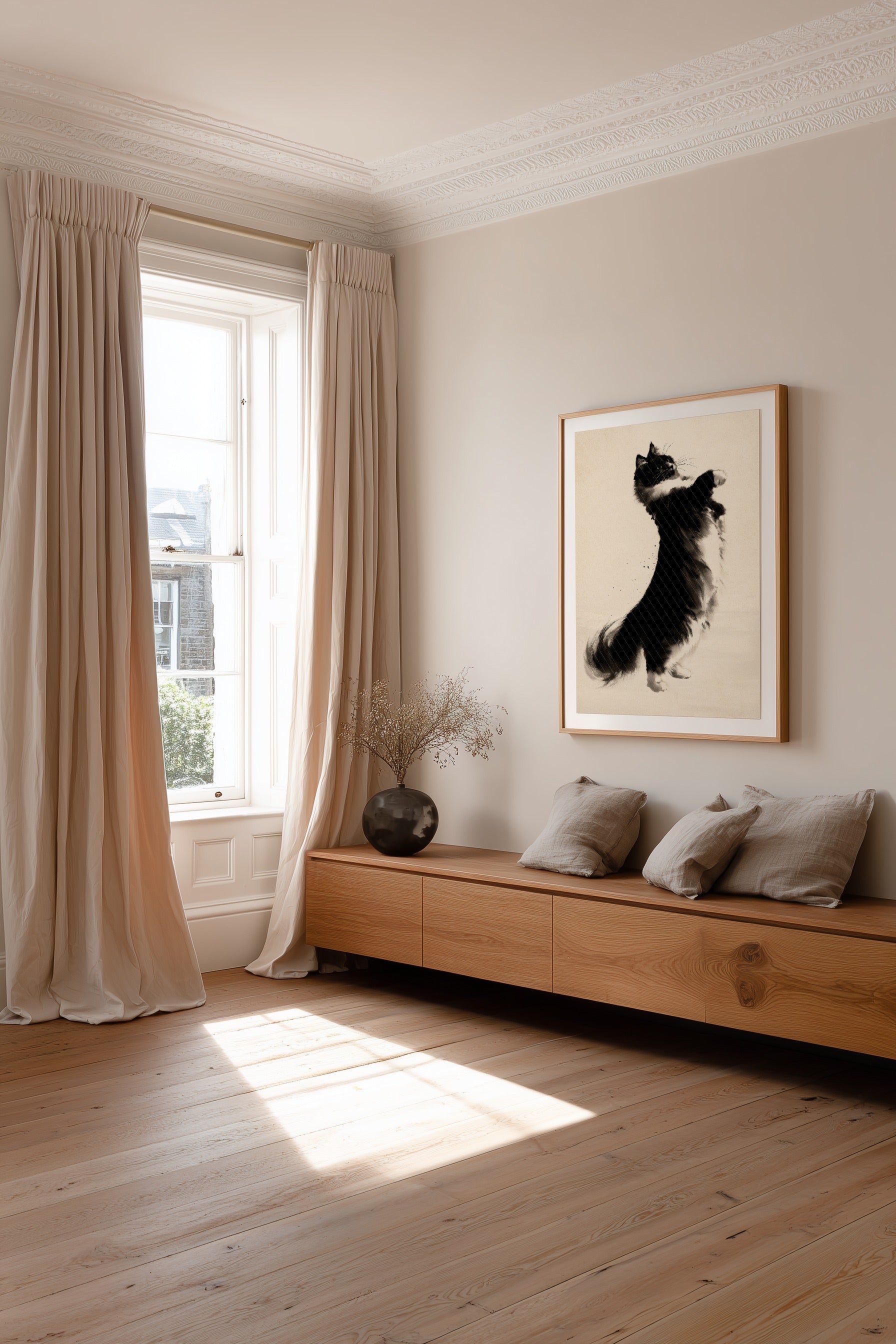 A styled interior room with a wooden bench, beige curtains, a window, and a framed black-and-white artwork on the wall.