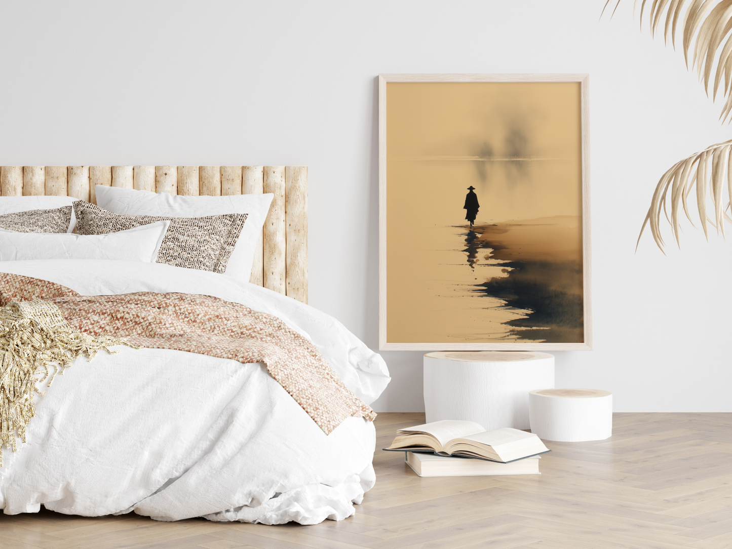 Sumi-e style ink wash print of a solitary figure standing at the water's edge in mist, framed in light wood in a neutral bedroom above stacked books, Yugen Print
