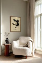 Kintsugi Dancing Crane print shown framed in a reading corner, a red-crowned crane lifts a foot and arches its wings, ink splashing and gold pooling at its feet