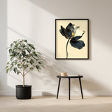 Kintsugi Lotus print shown framed in a living room (4:5 version), a dark ink lotus flower with gold-edged petals on a curved stem above rippling water