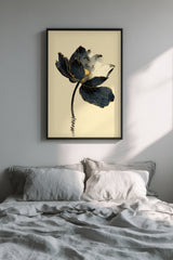 Kintsugi Lotus print shown framed in a bedroom, a dark ink lotus flower with gold-edged petals on a curved stem above rippling water