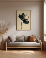 Kintsugi Lotus print shown framed in a living room, a dark ink lotus flower with gold-edged petals on a curved stem above rippling water