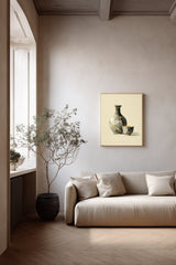 Kintsugi Sake Set print shown framed in a living room with plaster walls, a grey sake flask and small cup mended with gold kintsugi seams on a cream ground