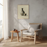 Kintsugi Sake Set print shown framed in a reading corner, a grey sake flask and small cup mended with gold kintsugi seams on a cream ground
