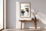 Low Tide sumi-e print in an oak frame above a narrow wood console in a bright entryway