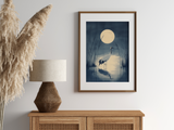 Crane in the Reeds print in a wood frame above a rattan sideboard with a lamp and pampas grass, Yugen Print