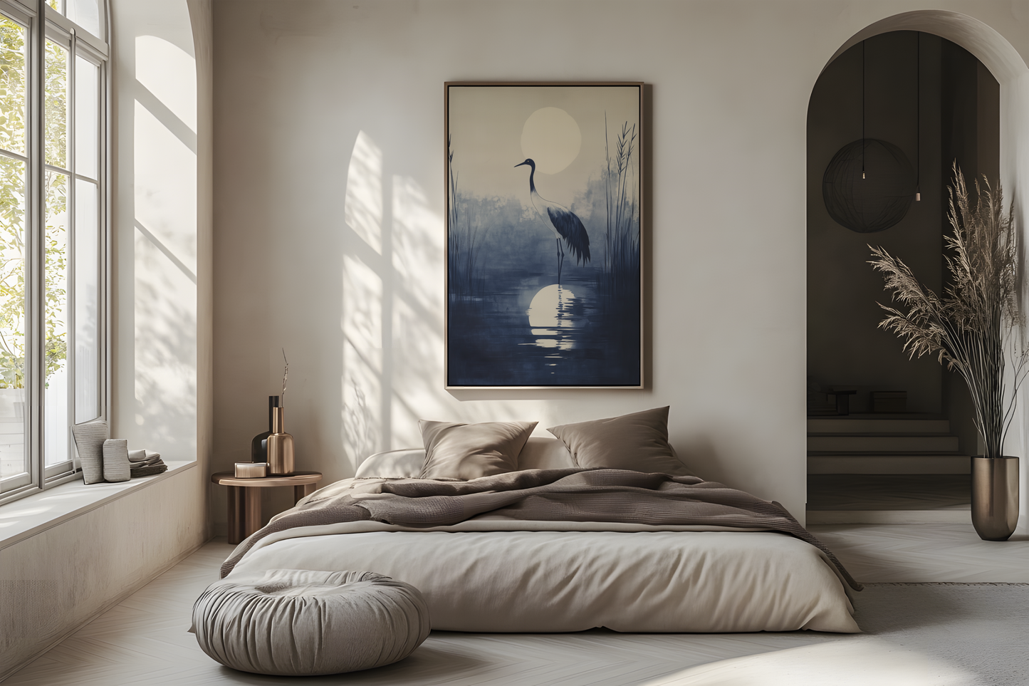 Sumi-e style indigo ink print of a crane silhouetted beneath a full moon, oak frame above a linen bed in a bright airy Japandi bedroom, Yugen Print