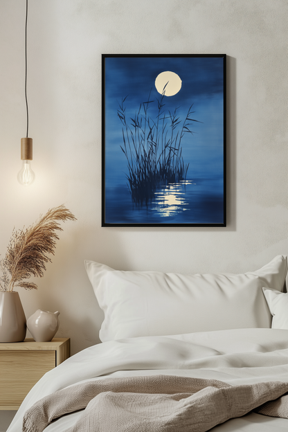 Sumi-e style indigo ink print of moonlit reeds and a full moon reflection, black frame above white bedding beside a warm pendant light in a serene evening bedroom, Yugen Print