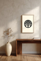 Sagari-fuji wisteria kamon print in black on cream, framed above a dark wood console table with a vase of dried branches