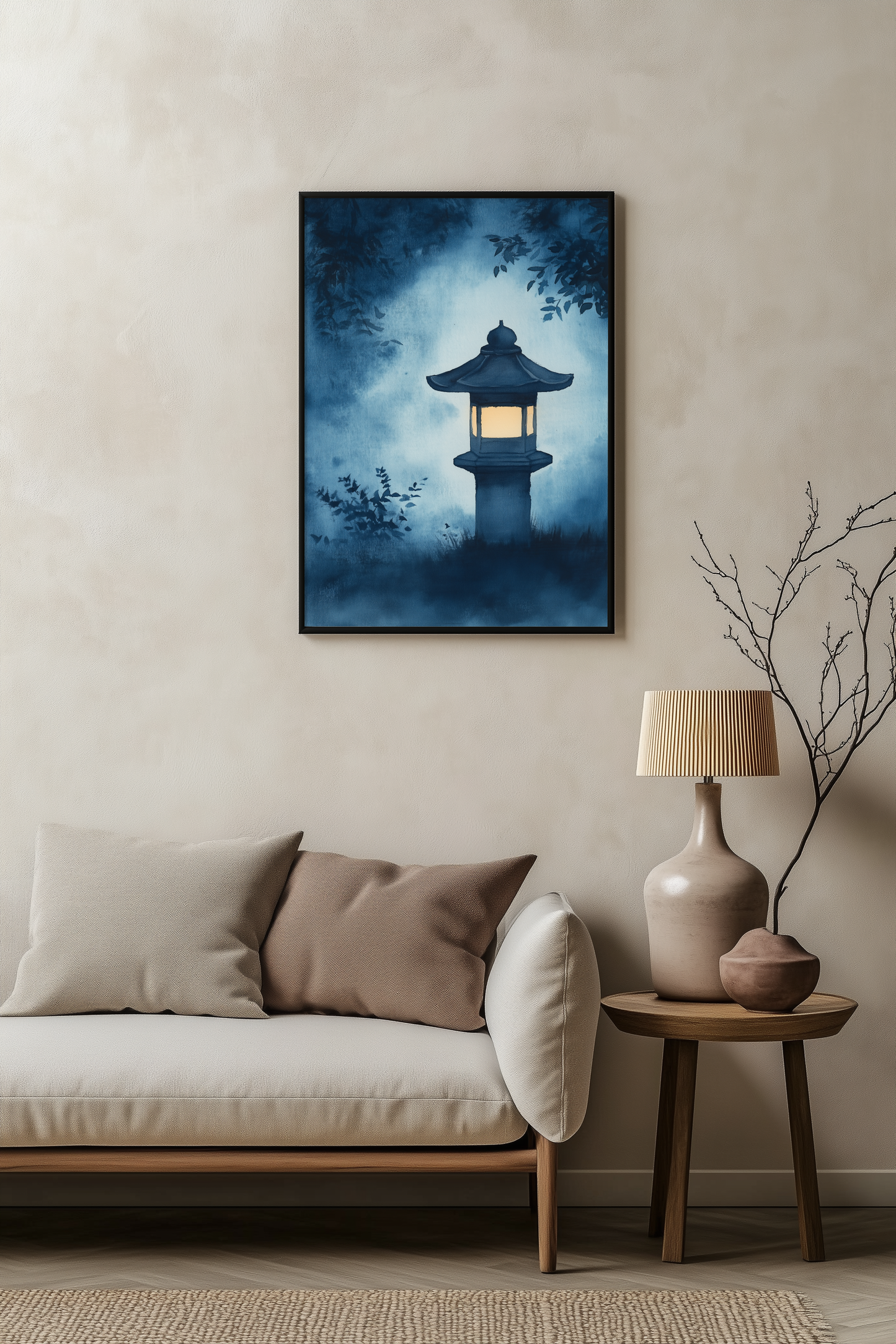 Sumi-e style indigo ink print of a glowing Japanese stone lantern at night, black frame above a pale linen sofa with a wooden side table and ceramic lamp, Yugen Print
