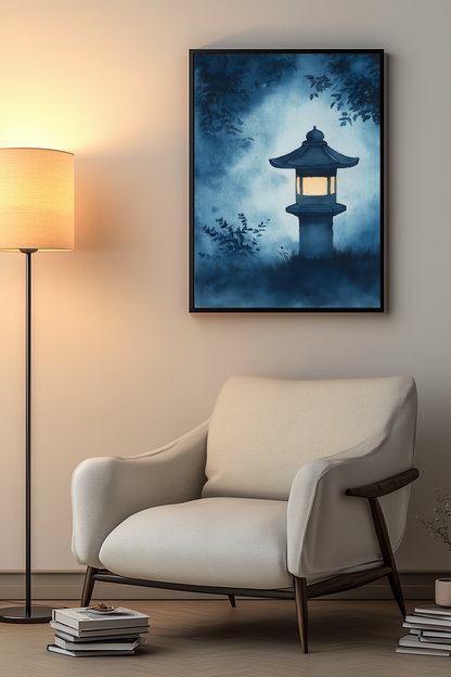 Sumi-e style indigo ink print of a glowing stone lantern in a misty night garden, black frame above a cream armchair beside a warm floor lamp in a cosy reading nook, Yugen Print