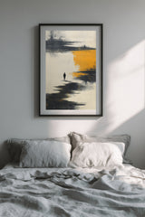 The Amber Shore sumi-e print in a black frame above a bed with grey linen bedding