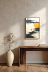 The Amber Shore sumi-e print framed above a dark wood console and a cream vase on a plaster wall