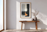 The Ember Stair sumi-e print in an oak frame above a narrow wood console in a bright entryway
