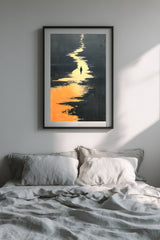 The Golden River sumi-e print in a black frame above a bed with gray linen bedding