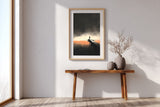 The Last Pier sumi-e print in an oak frame above a narrow wood console in a bright entryway