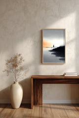The Narrow Crossing sumi-e print framed above a dark wood console and a cream vase on a plaster wall