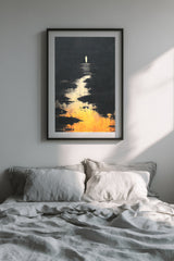 The Pale Wanderer sumi-e print in a black frame above a bed with gray linen bedding