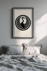 Tsuru crane kamon print in black on cream, framed above the bed in a calm bedroom with grey linen bedding
