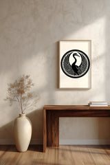 Tsuru crane kamon print in black on cream, framed above a dark wood console table with a vase of dried branches