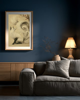 Sumi-e style ink print of a white nine-tailed fox seated with its gaze lifted toward a plum blossom branch, tails flowing into mist, black ink on cream paper, framed in oak on a deep blue living room wall above a grey sofa with a table lamp, Yugen Print