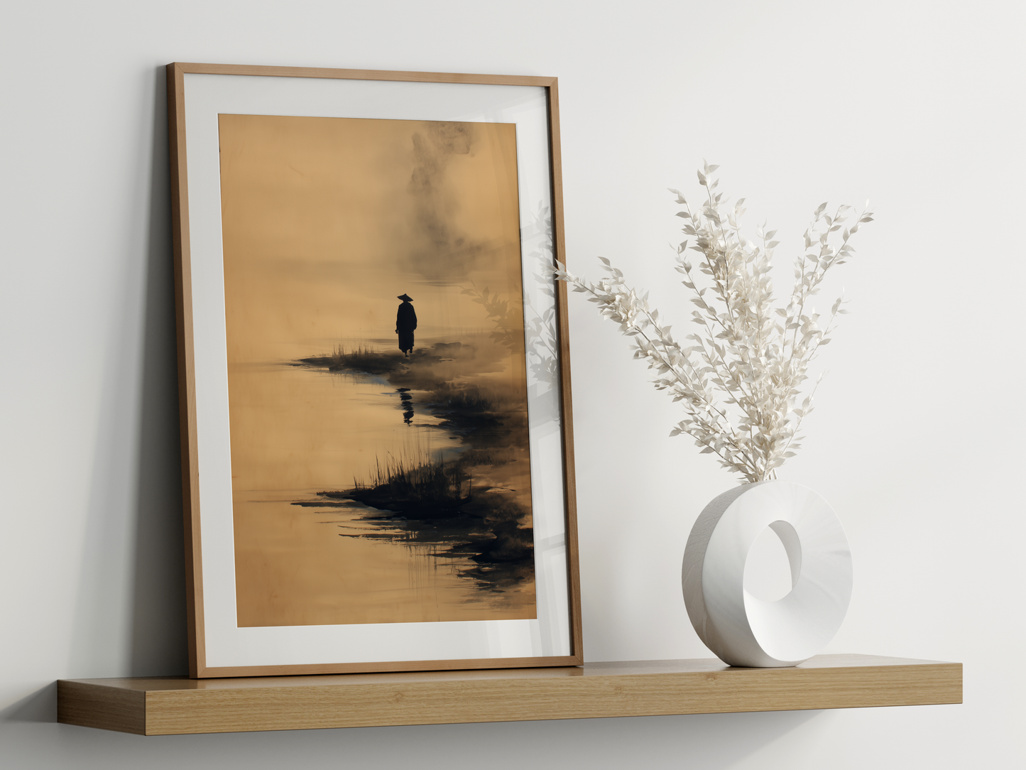 Sumi-e style ink print of a lone figure walking a shore with a faint reflection, framed in oak on a floating shelf beside a white vase, Yugen Print