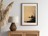 Sumi-e style ink wash print of a small figure seated beside still water, in an oak frame above a cane sideboard with a rattan lamp and pampas, Yugen Print