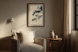 Winter Pine print in a reading nook with linen chair, side table, and warm lamplight, Yugen Print.